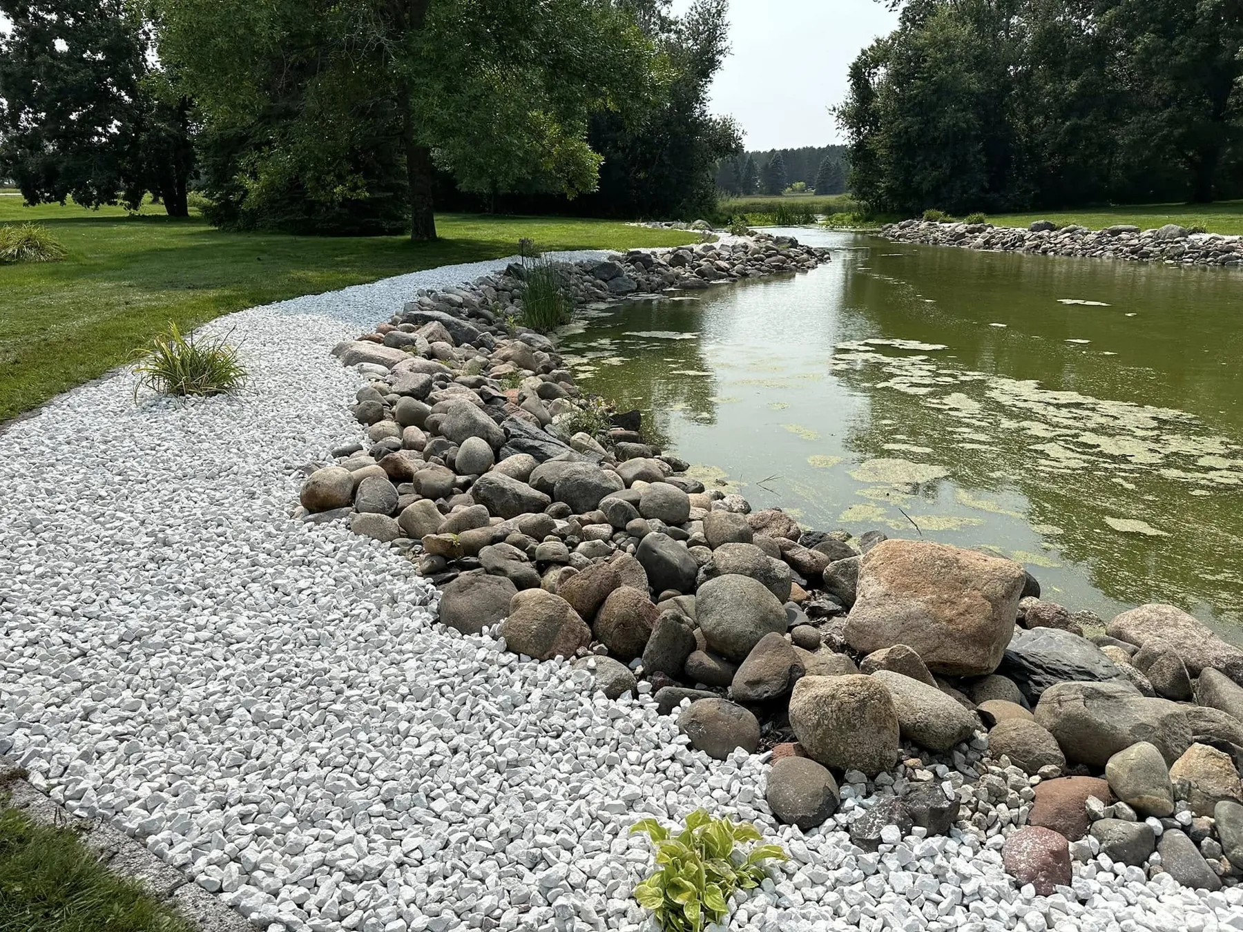 Lakeshore edge restored with river rock and fresh stone
