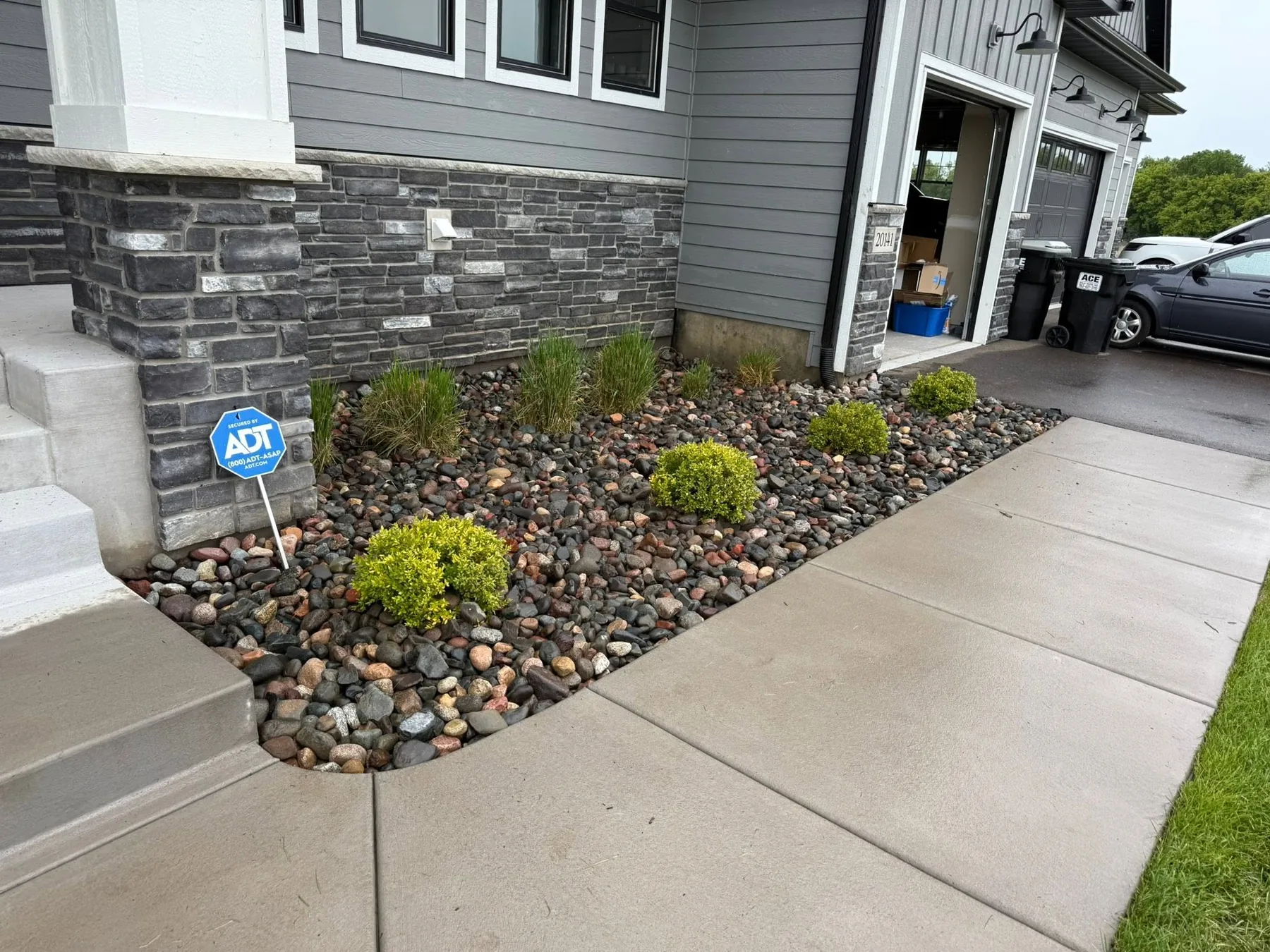 Fresh decorative stone and planted shrubs beside a house